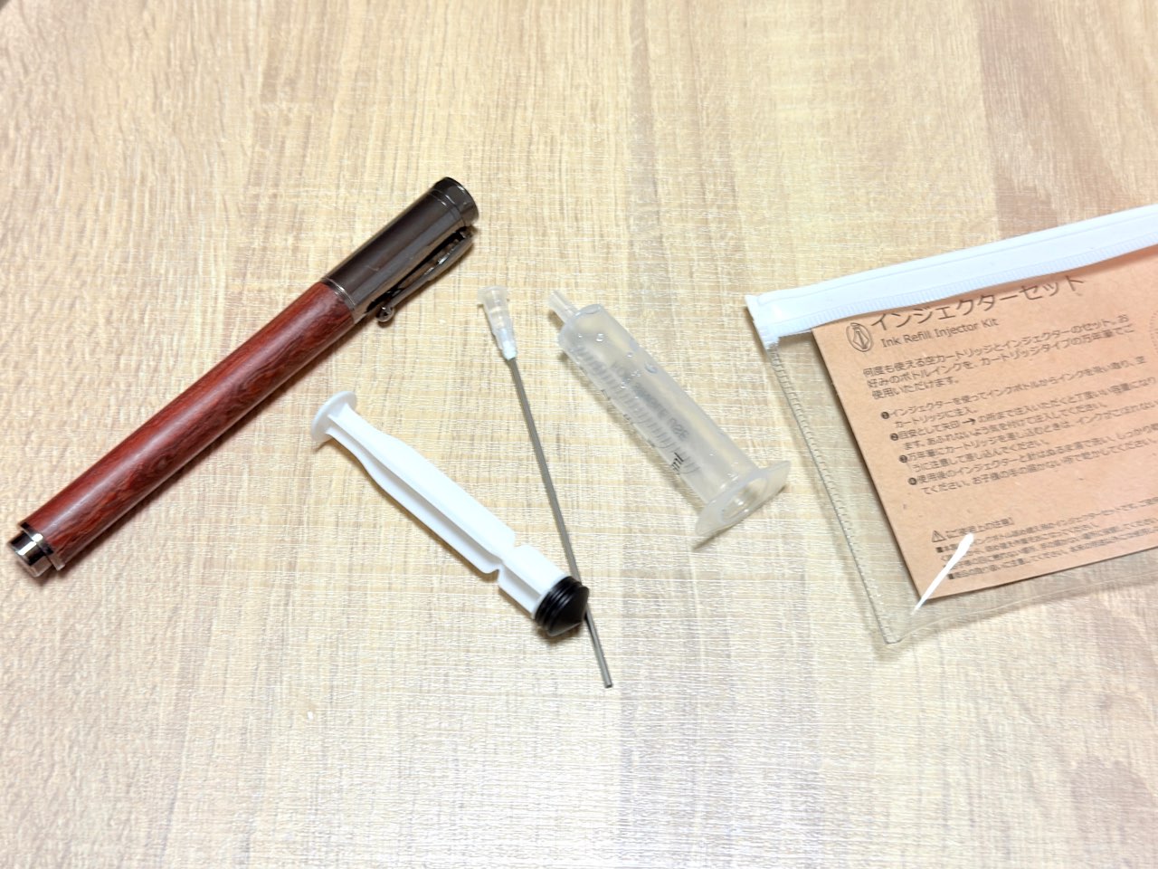 万年筆と分解した注射器